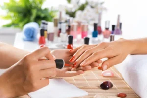 Woman in salon receiving manicure